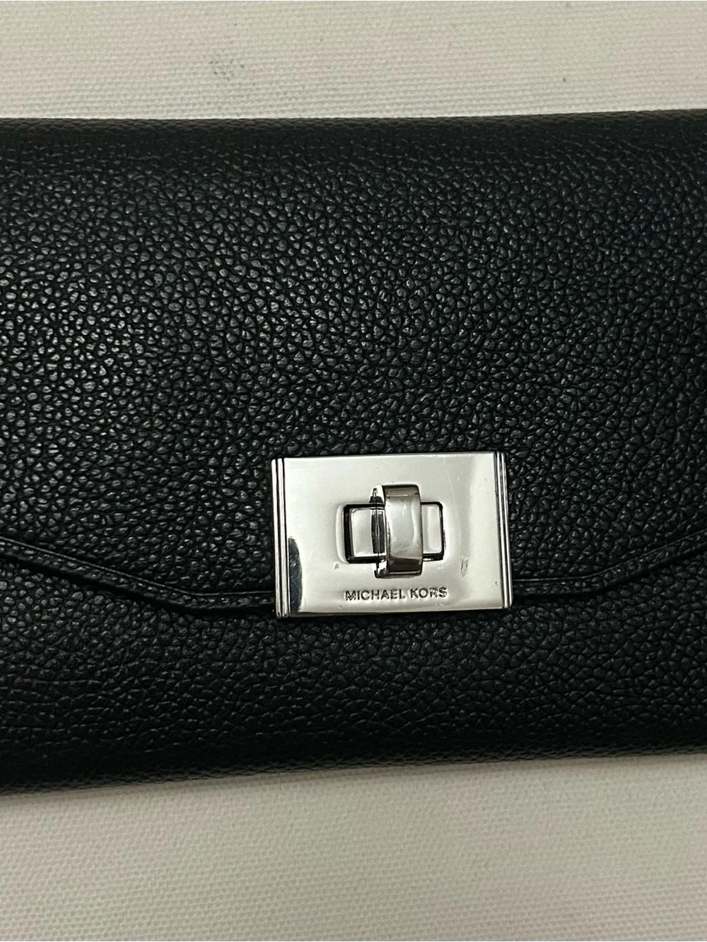 Michael Kors White Perforated Satchel with Black Trim and matching black wallet.